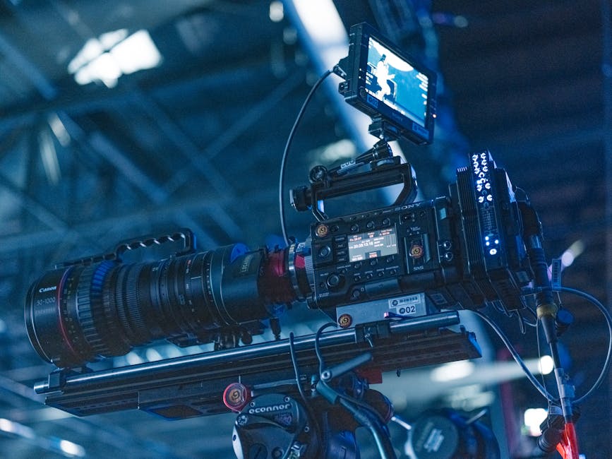 Close-up of a high-end video camera setup in a professional studio setting ready for filming.