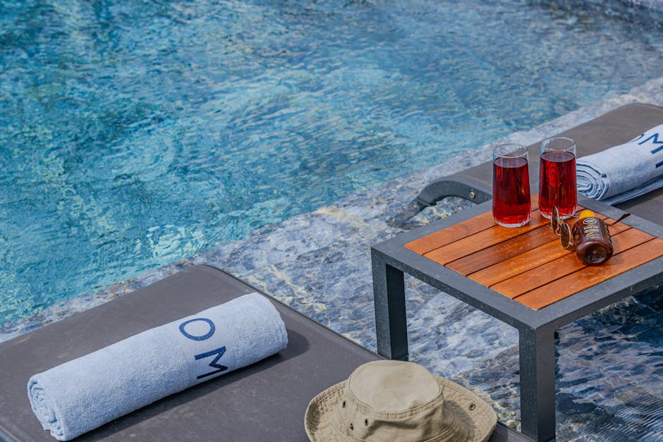 Enjoy a sunny day by the pool with refreshing red drinks and lounge chairs.