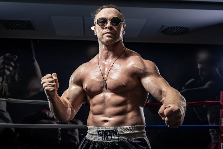 A powerful boxer poses confidently in a boxing ring wearing sunglasses and sports attire.