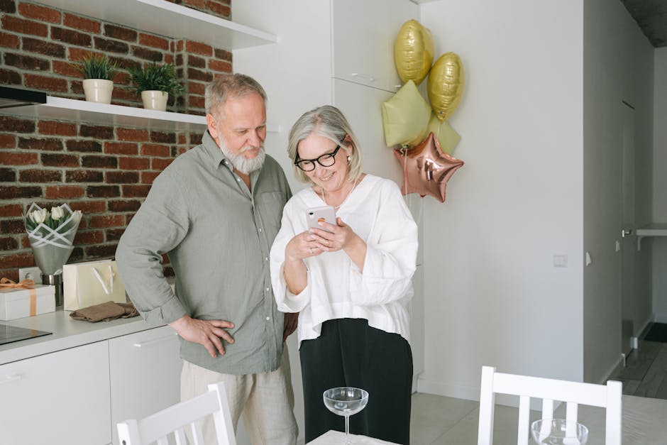 A cheerful senior couple enjoying a video call together in a cozy kitchen.