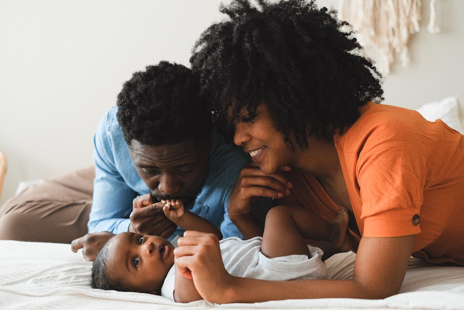 An affectionate family interacting joyfully with their baby, showcasing love and closeness.