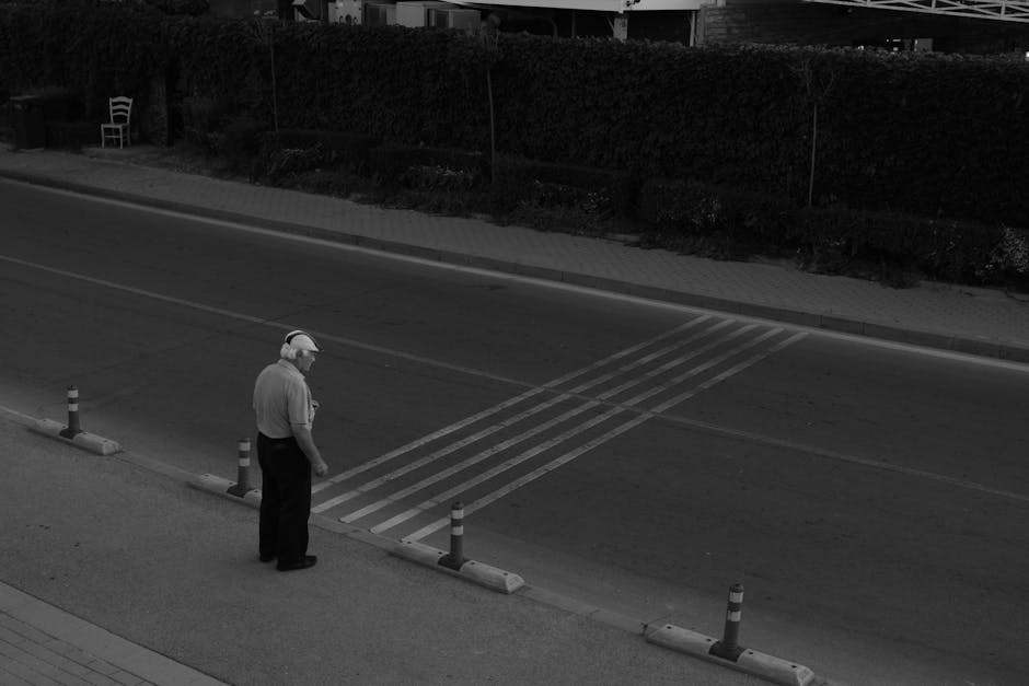 Senior adult crossing an empty road, capturing solitude and introspection.
