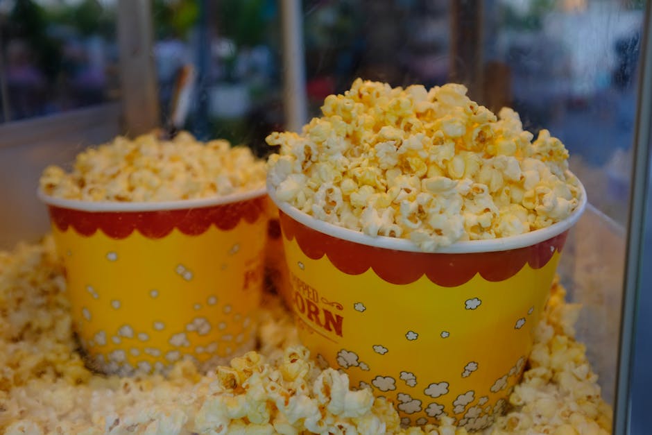 Delicious buttery popcorn in bright yellow buckets, perfect for movie night snacks.