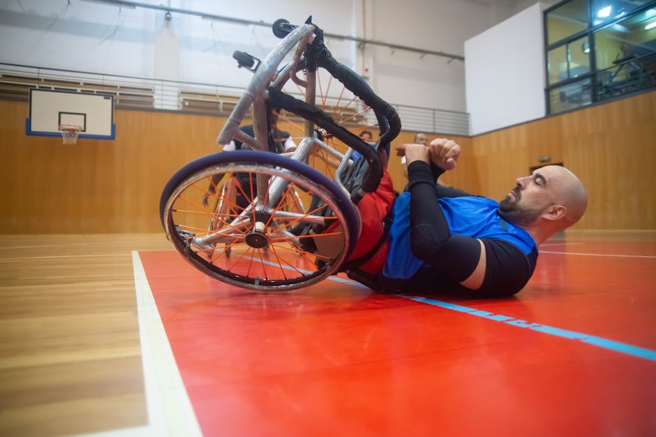 An athlete in a wheelchair practices basketball indoors, showcasing determination.