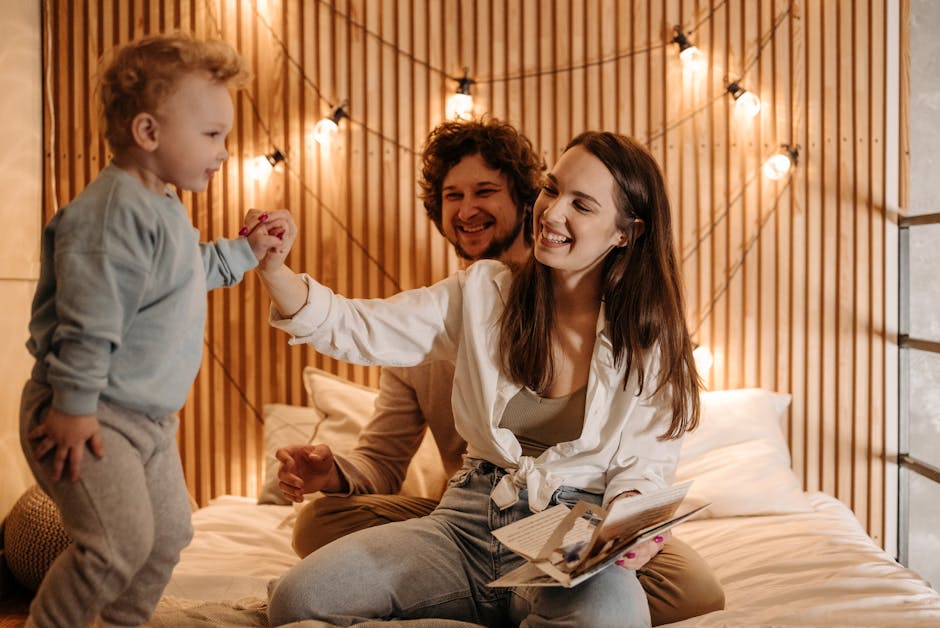Joyful family time on a cozy bed with smiling parents and playful child.