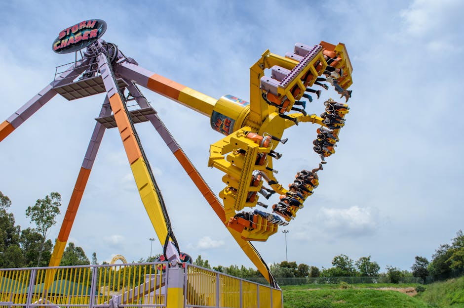 High-energy thrill ride at carnival featuring the Storm Chaser with people having fun.