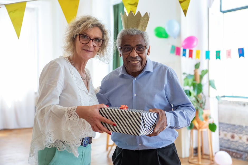 A happy birthday celebration with friends exchanging gifts indoors.