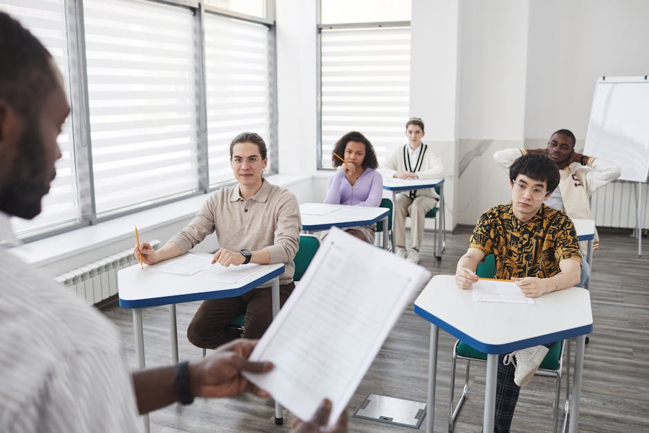 A diverse group of students attentively taking an exam in a classroom setting.