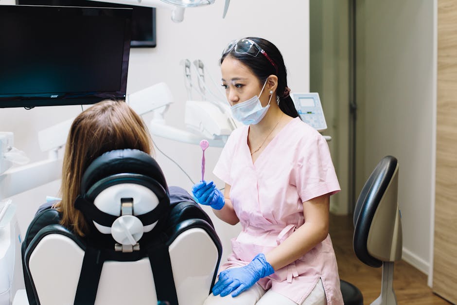 A young dentist in a dental clinic assisting a patient with oral hygiene. Medical professional setting.