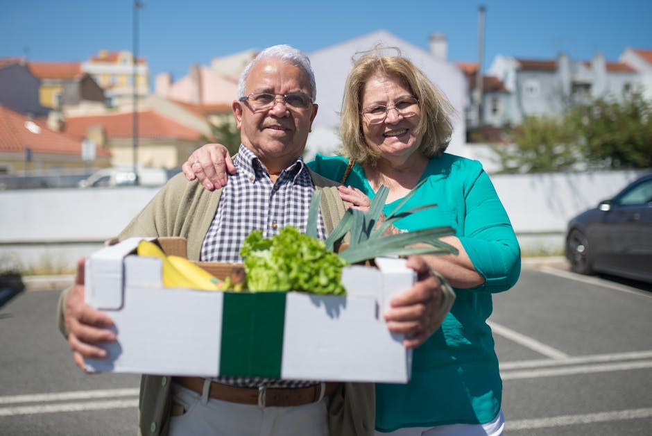 Elderly couple enjoying a sunny day shopping in Portugal with a box of fresh produce.