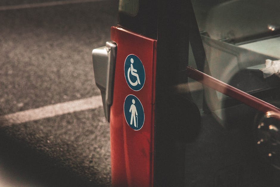 Close-up view of accessibility and elderly symbols on a red city bus.