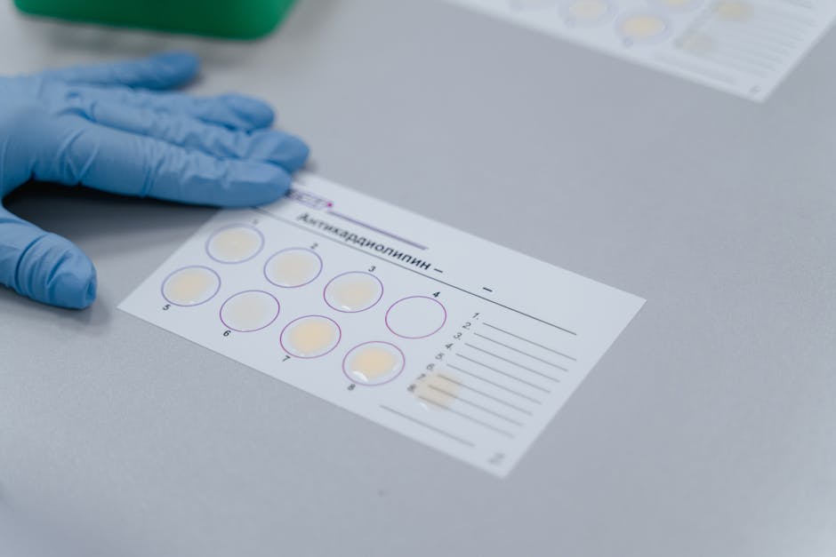 Lab test result form with gloved hand, indicating a scientific experiment setup.