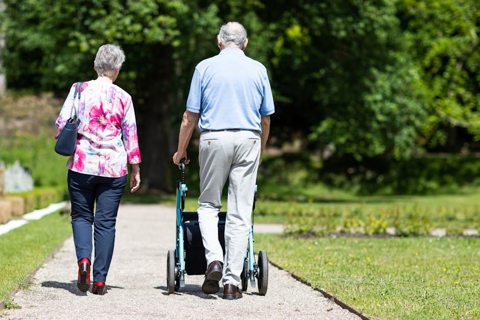 Senior couple walking in a park during summer, supporting mobility and togetherness.