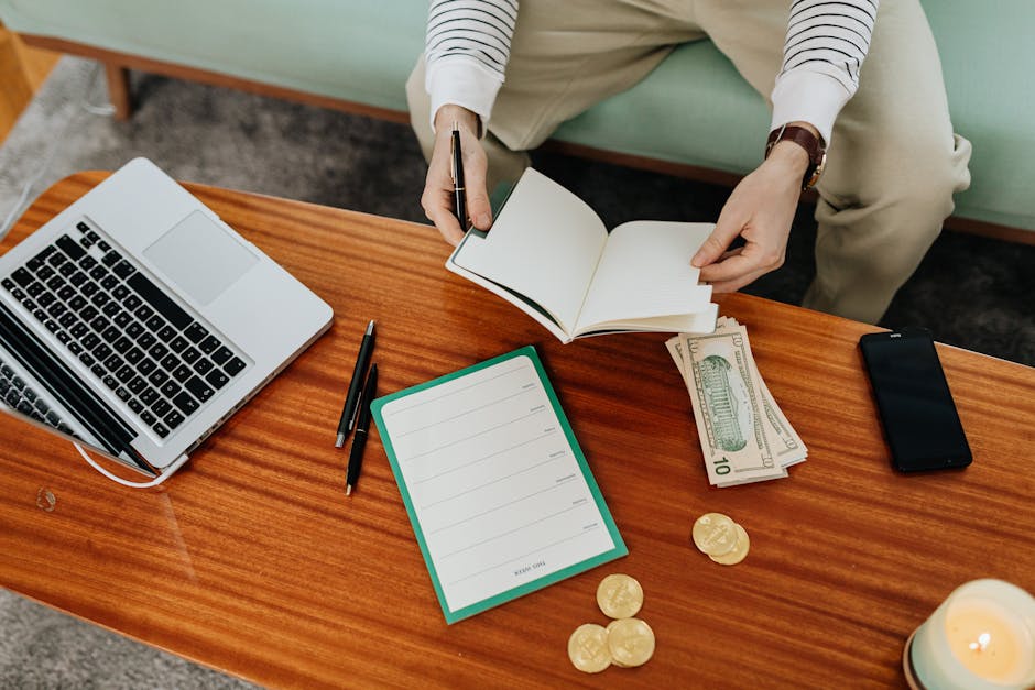 Top view of a workspace with cash, notebook, and laptop, ideal for finance or business themes.