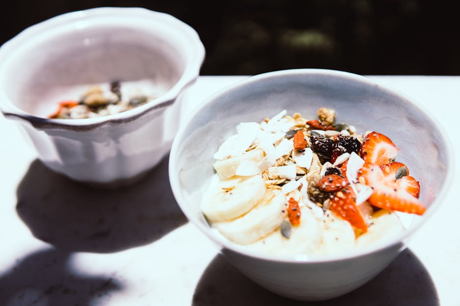 Discover a nutritious breakfast bowl featuring sliced bananas, strawberries, and granola, perfect for a healthy start.