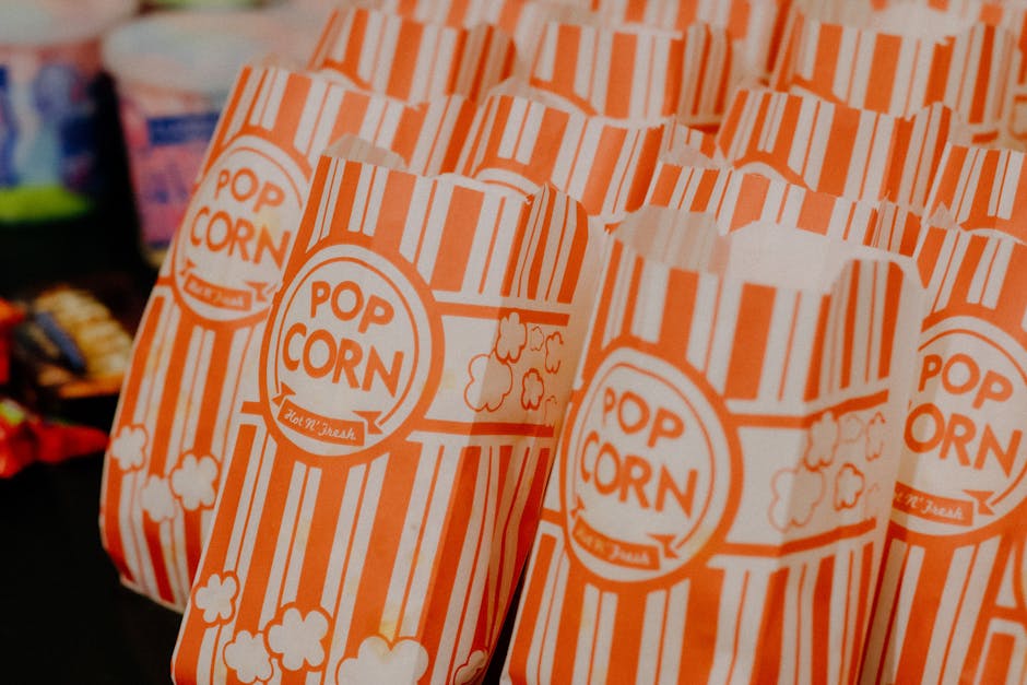 Colorful striped popcorn bags neatly arranged, ready for serving at a concession stand.