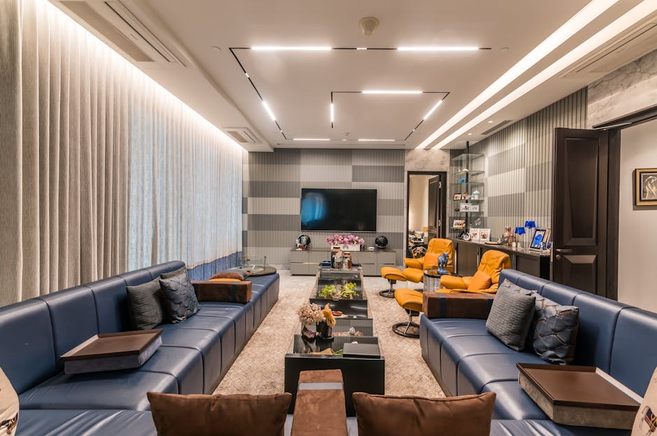 Stylish and comfortable modern living room with blue sofas and armchairs.