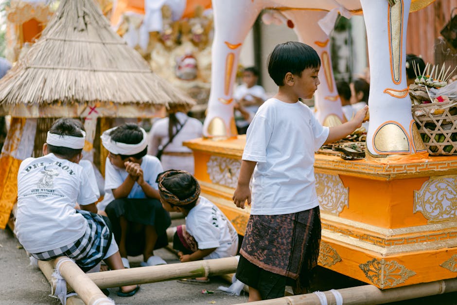 Children engaged in activities during a vibrant cultural festival with traditional attire and decorations.
