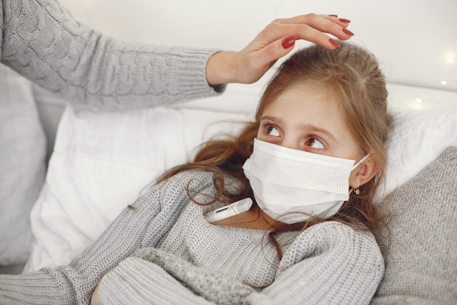 Young girl resting in bed wearing a mask, with a caregiver attending her health.