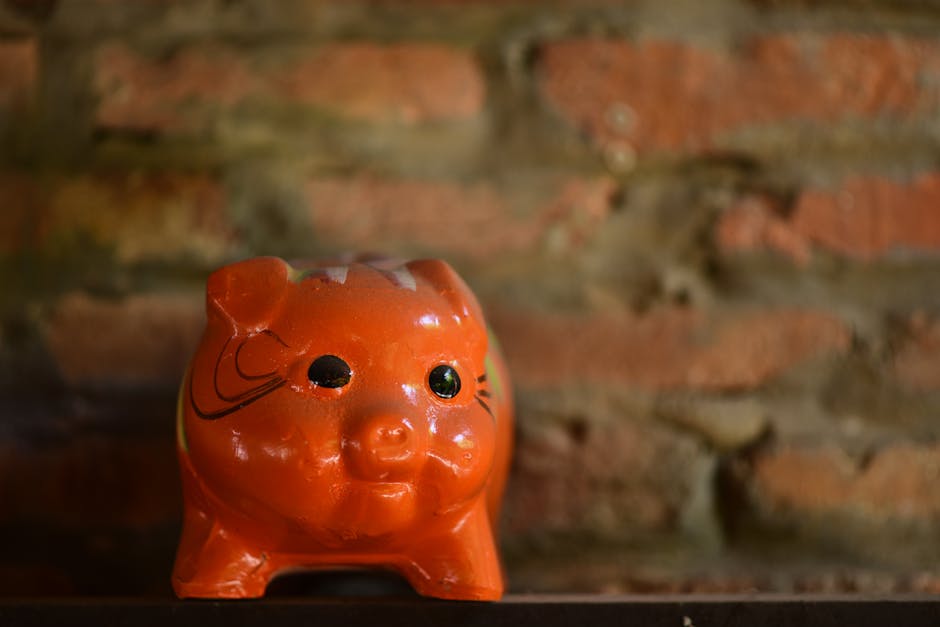 Orange ceramic piggy bank on shelf against rustic brick wall background, perfect for saving concepts.