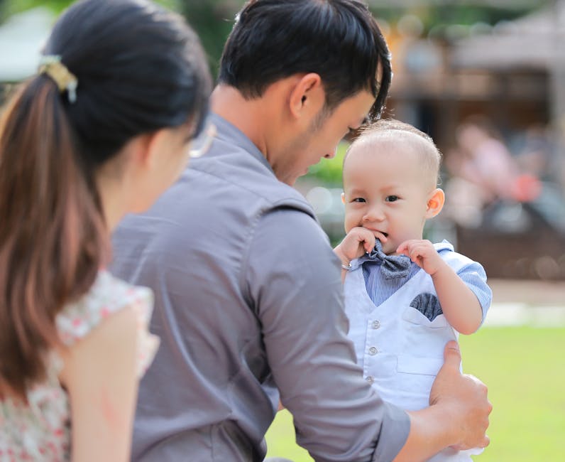 Father bonding with his baby boy outdoors. Heartwarming family moment captured in daylight.