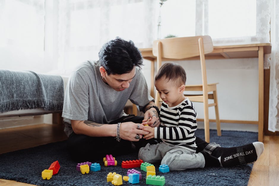 Father and son bond playing with colorful blocks in a cozy home setting.