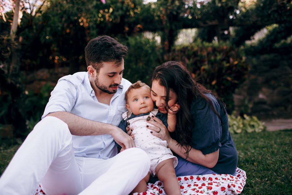 A family enjoys a sunny outdoor picnic, focusing on the love and joy shared amongst them.