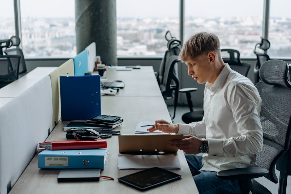 Young professional working diligently in a bright, modern office setting.