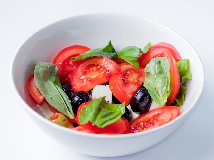 Delicious and colorful caprese salad featuring fresh ingredients like tomatoes, basil, and olives.