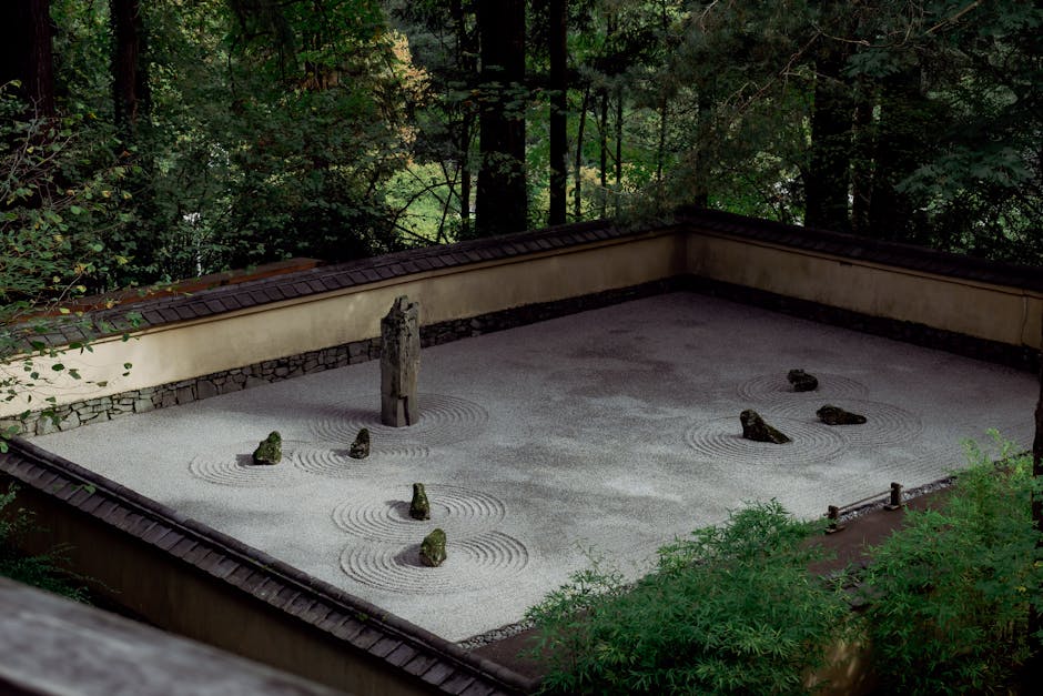 A serene zen rock garden in Portland surrounded by lush greenery, ideal for mindfulness.