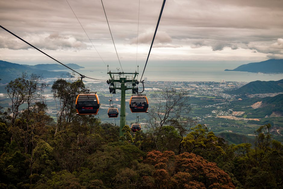 Aerial view of cable cars soaring over the lush landscape of Bana Khurd, offering a stunning vista.