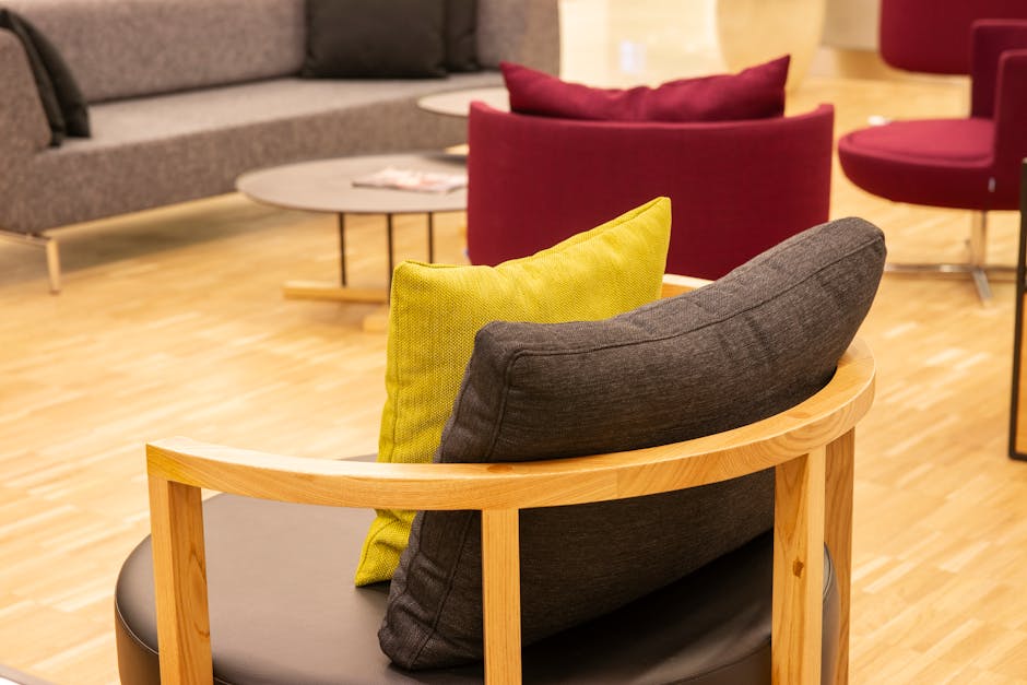 Cozy office lounge area showcasing modern armchairs with throw pillows.