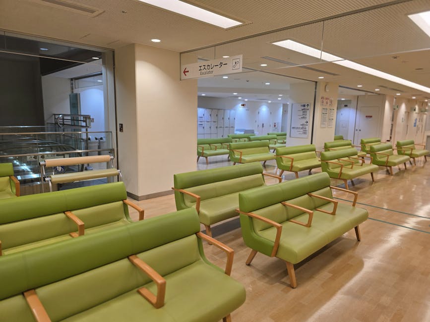 Empty hospital waiting area with green seats in Shibuya, Tokyo.