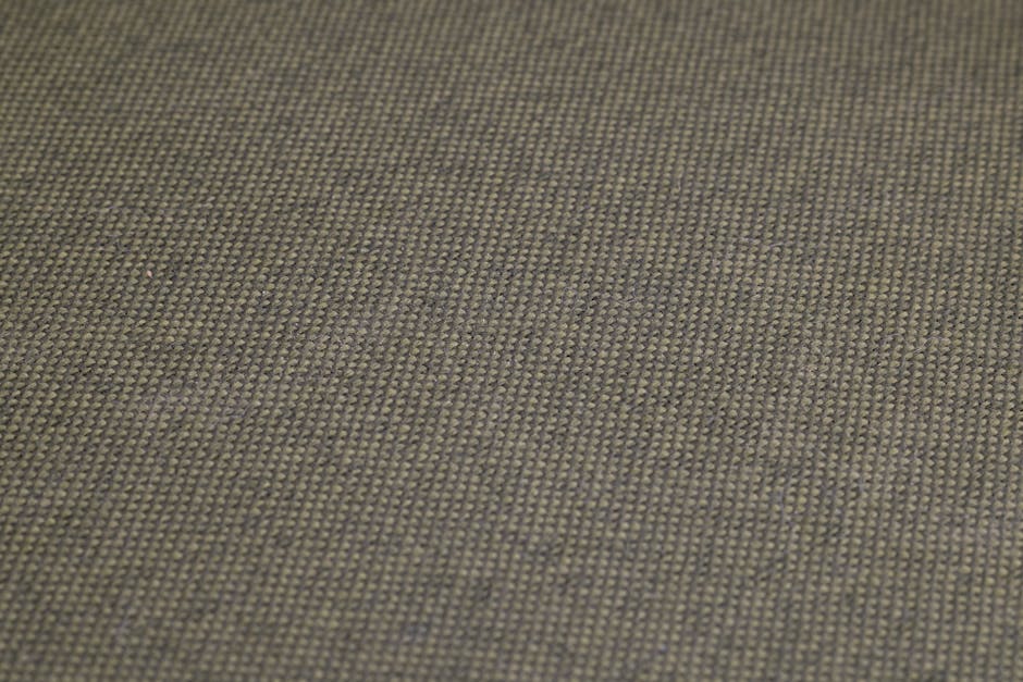 High-resolution close-up of olive green woven fabric, showcasing detailed texture and pattern.
