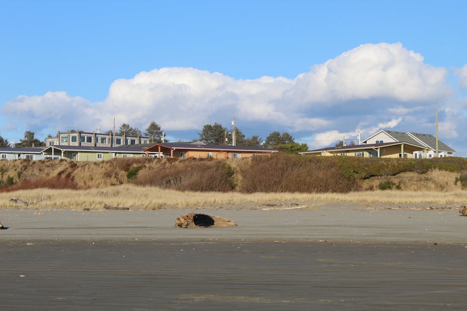 Charming coastal homes with scenic beach and blue sky in Oregon.