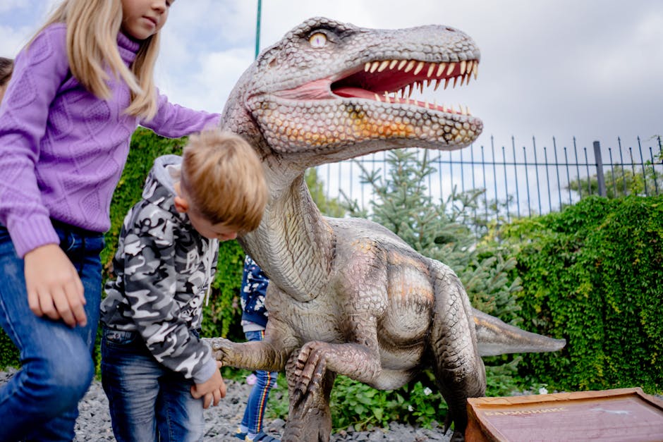 Children playing around an outdoor dinosaur statue at a museum exhibit, having fun.