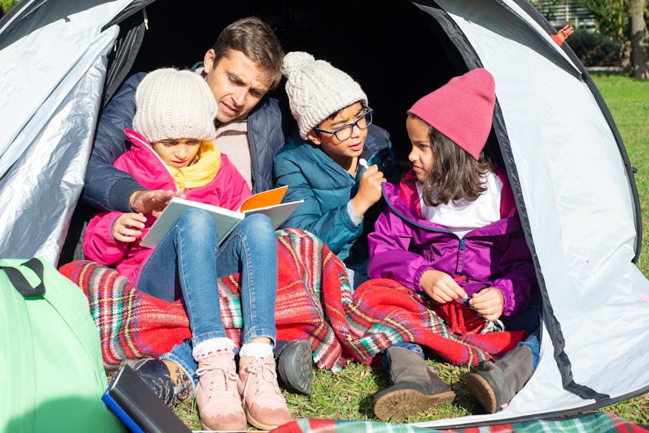 Family enjoying a cozy reading session in a tent during a camping adventure.