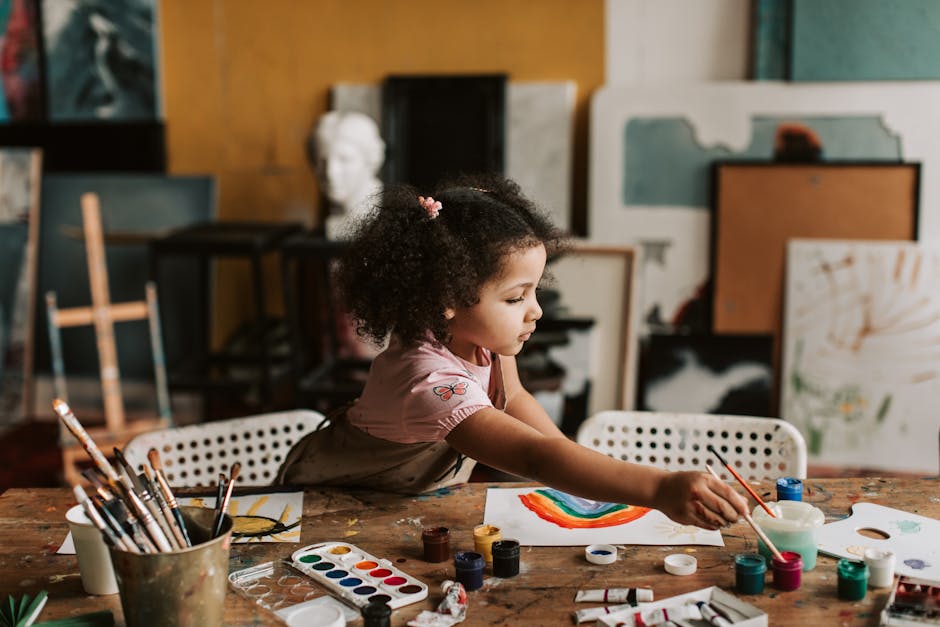 A young girl painting a rainbow in a lively art studio filled with supplies.