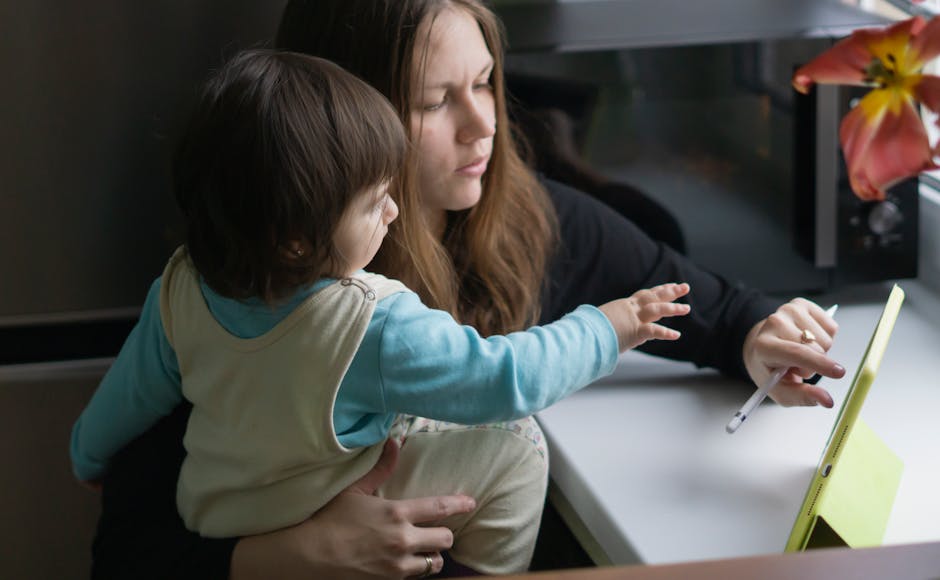A mother and child interacting with a tablet, emphasizing parenting and technology.