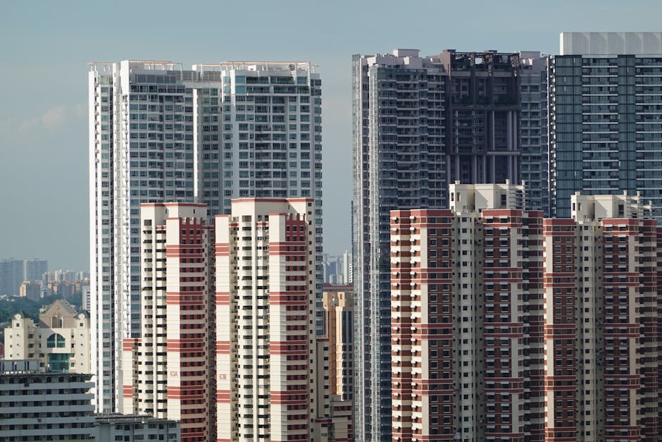A cityscape featuring tall residential high-rise buildings under a clear sky.