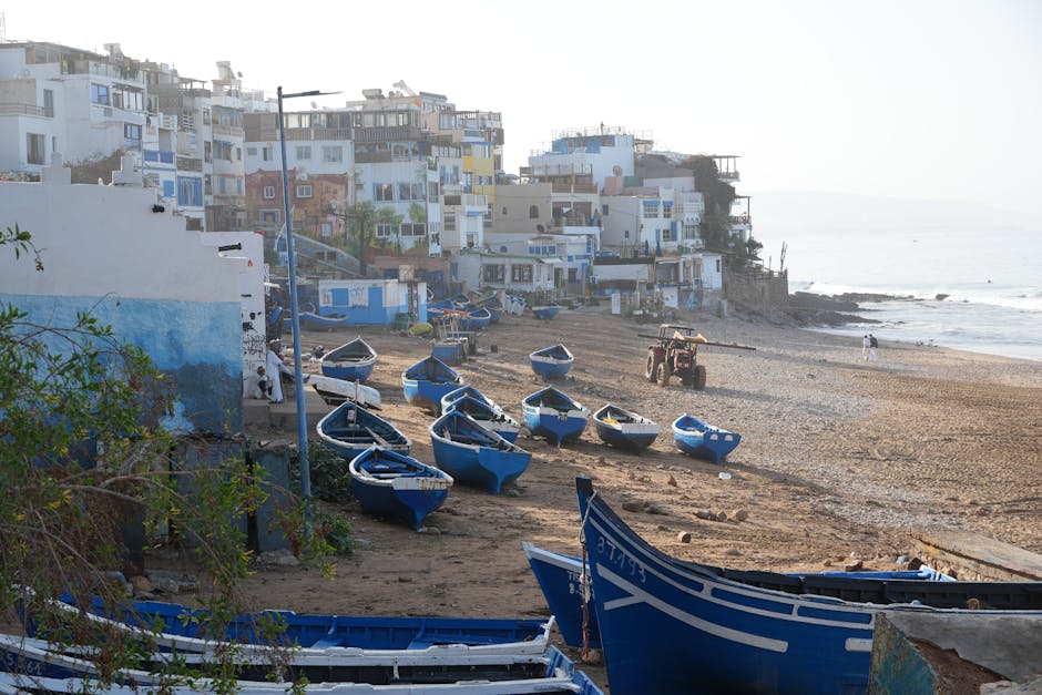 Charming seaside view of fishing boats on Taghazout beach, Souss-Massa, Morocco.