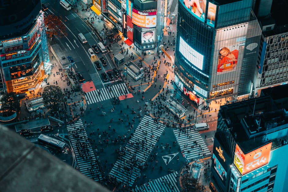 Captivating aerial shot of the bustling Shibuya Crossing in Tokyo at night, showcasing vibrant city lights.
