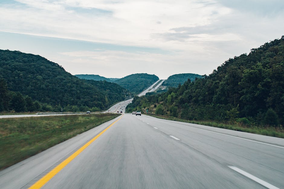 A picturesque highway running through lush green hills, ideal for road trips.
