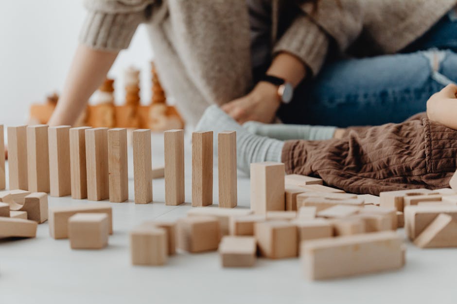 A child playing with wooden blocks indoors, focusing on development and creativity.
