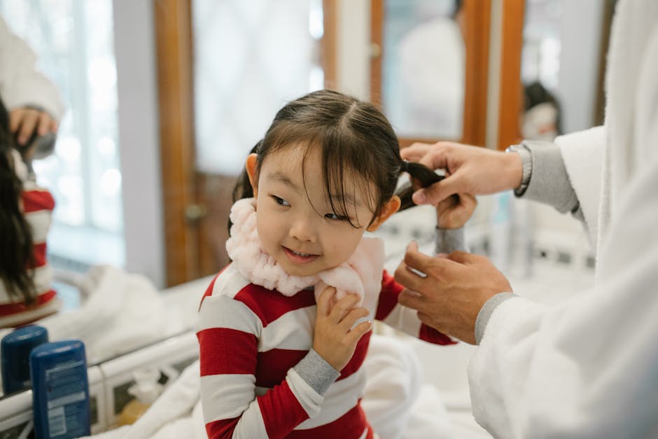 Caring father helps daughter with her hair in a cozy home bathroom.