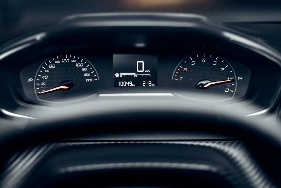 Detailed view of a modern car dashboard showing speedometer, odometer, and tachometer.