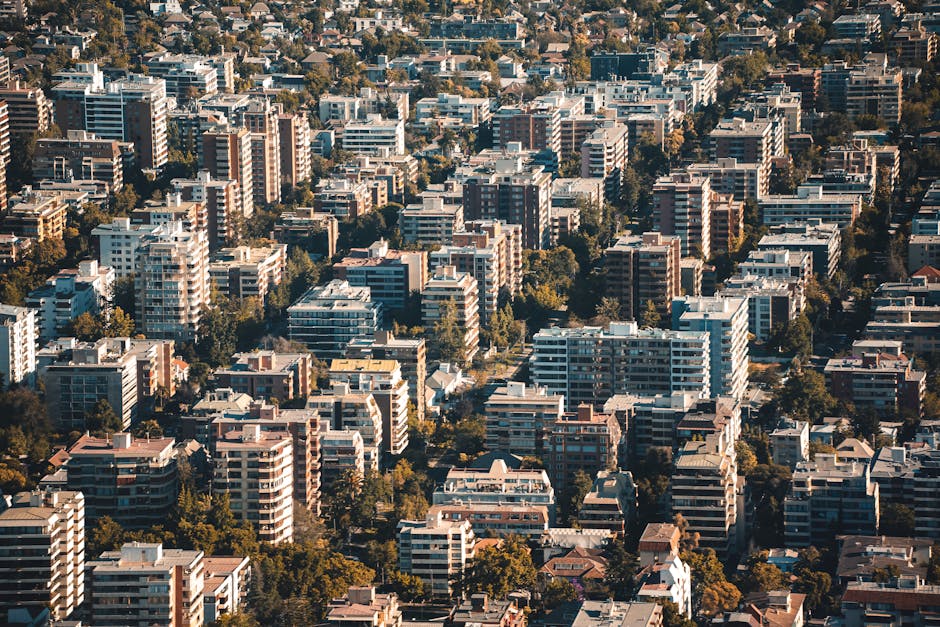 Stunning aerial view of a densely packed urban residential area with tall buildings and greenery.