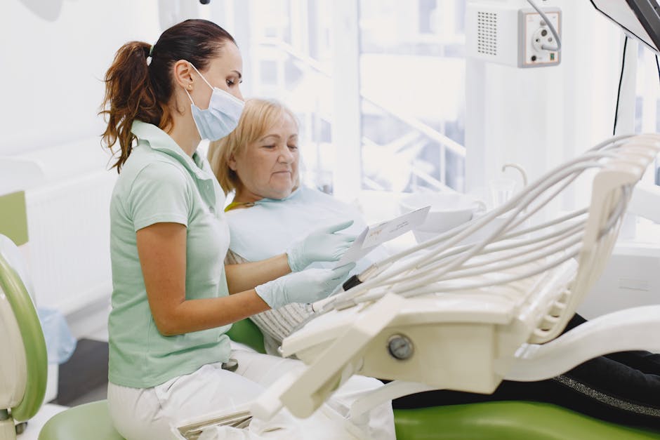 A female dentist discusses dental care with an elderly woman in a modern clinic setting.
