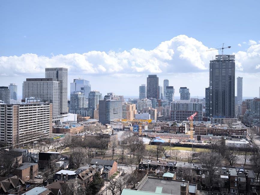 View of Toronto skyline showcasing modern skyscrapers and urban development under clear skies.