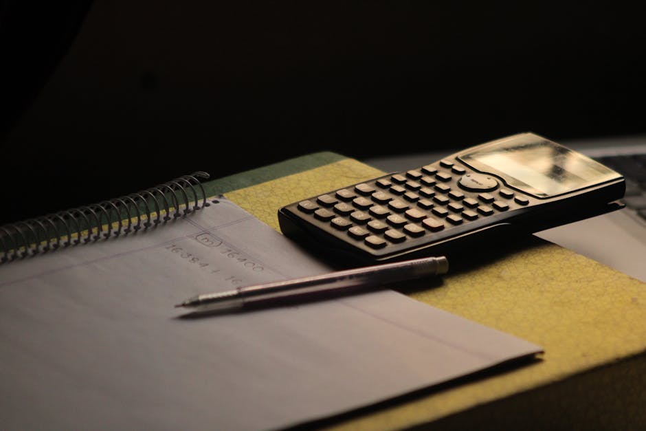 Close-up of a calculator and notebook on a study desk. Ideal for education themes.
